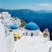 a view of a blue domed building on the edge of a cliff